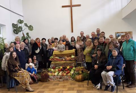 group of people around a harvest display
