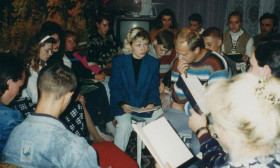 a group of people crowded into a small flat