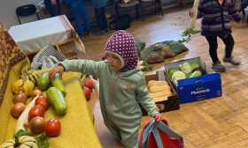 two children examine the harvest display