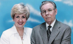 an elderly couple posing for a portrait