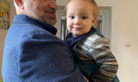 a man holds a smiling child