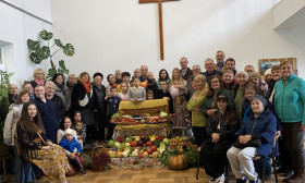 group of people around a harvest display