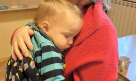 woman holding a sleeping child