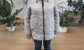 a woman standing with a grocery bag