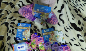 a young girl surrounded by infant products