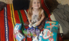a young girl surrounded by infant products