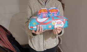 woman holding a bag of groceries and products