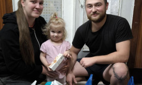 a young couple with a small girl