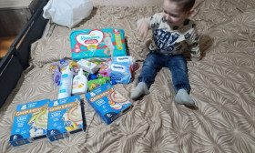 a young boy surrounded by infant products