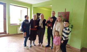 family standing in room with green walls